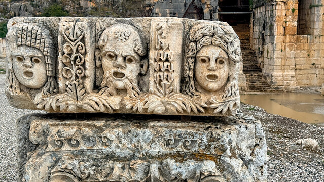 Ancient carved stone theater masks in weathered ruins with soft natural light, perfect for travel editorial, history features, heritage marketing, 5 May 2026 Subitica, Serbia