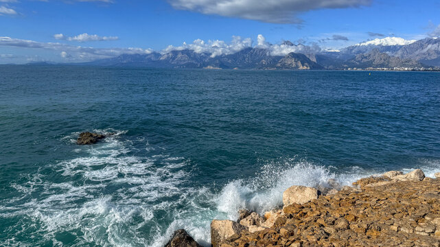 Rocky coastal seascape with waves and distant mountains in bright spring light, ideal for travel editorial, tourism promotion and social media, 5 May 2026 Subitica, Serbia