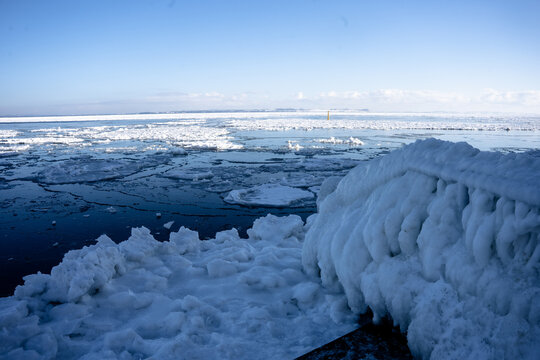 Frozen harbour at Aarhus Denmark with frozen over bridge