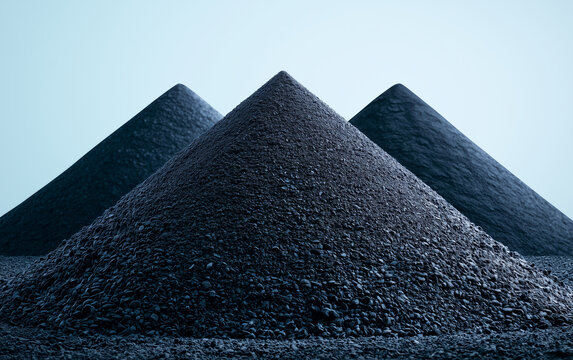 Piles of iron ore pellets used for steel production sit under a clear sky. These raw materials are vital for the global manufacturing sector and heavy industry.