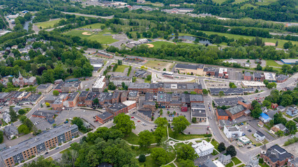 Naklejka premium Oneonta, NY, USA - June 7, 2026: Late afternoon spring aerial photo of downtown, business district, Oneonta, NY on an overcast day.