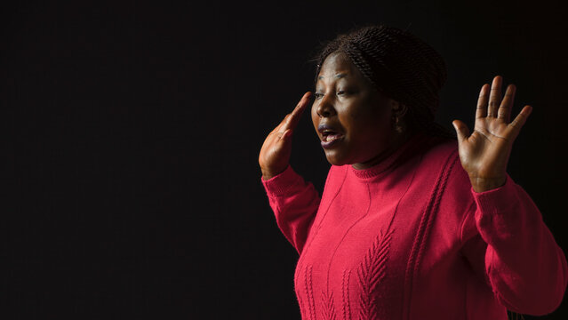 Young lady making I dont know gesture, lifting her shoulders implying confusion and uncertainty, with being ignorant and insecure with perplexed and bewildered reaction in isolated Black background.