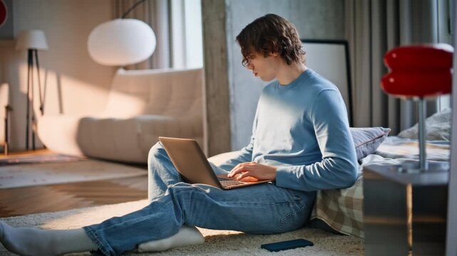 Young freelancer typing laptop working remotely. Relaxed man making coffee sip