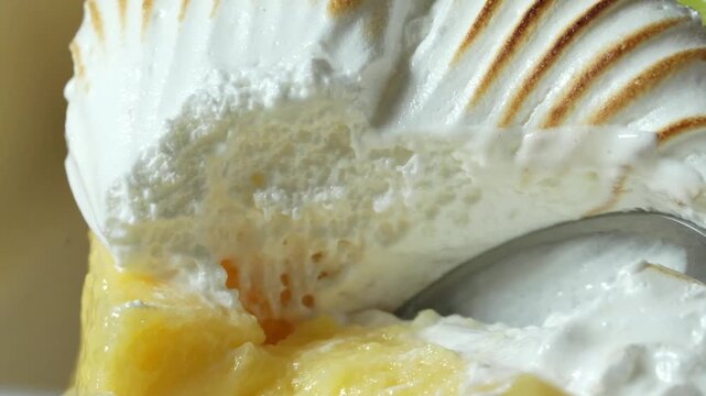 Spoon scooping toasted meringue from key lemon pie macro closeup video footage dessert texture and creamy fillin