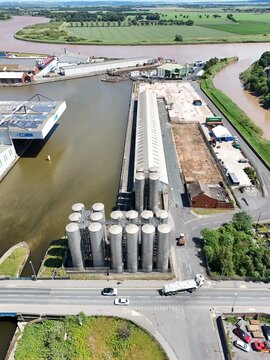 Aerial view of industrial silos and warehouse facilities located along the riverbank in Goole, England, United Kingdom.