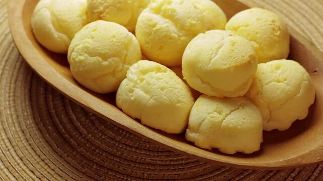 Homemade Brazilian Cheese Bread Stack Rotating In Wooden Bowl