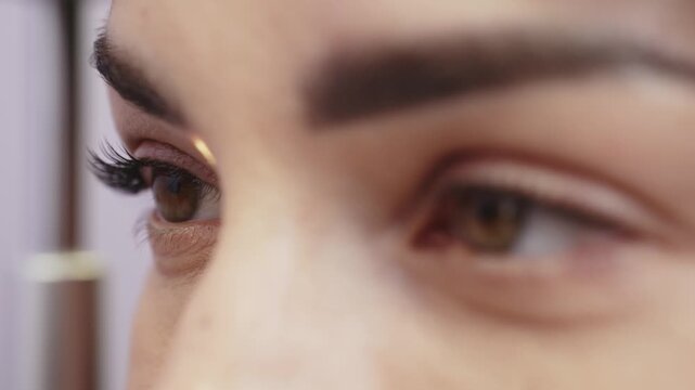 Female patient undergoing eye examination as doctor uses slit lamp to inspect cornea, highlighting detailed eye structure and visible light reflection in clinical setting