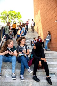 Students socializing on campus stairs.