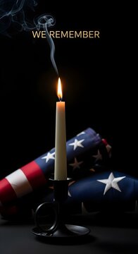 A single candle burns beside a folded flag in remembrance, symbolizing honor, respect, reflection, memorial tribute, peace, gratitude, and solemn national remembrance.