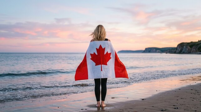 Canada day celebration woman with canadian flag on beach at sunset patriotic stock photo