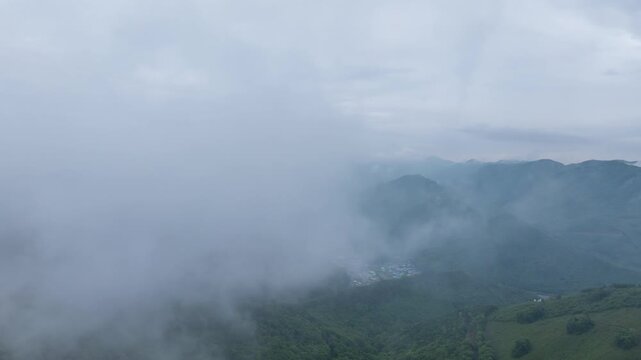 Aerial hyperlapse of thick fog and mist moving over Seongjusan Mountain in Boryeong, South Korea
