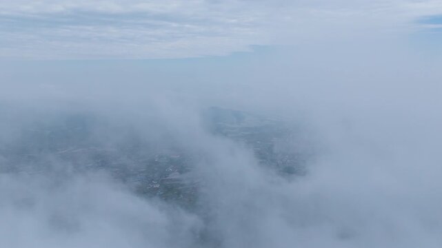 Aerial hyperlapse of thick fog and mist moving over Seongjusan Mountain in Boryeong, South Korea