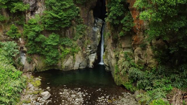 Salto do cabrito waterfall drone ascending view in azores