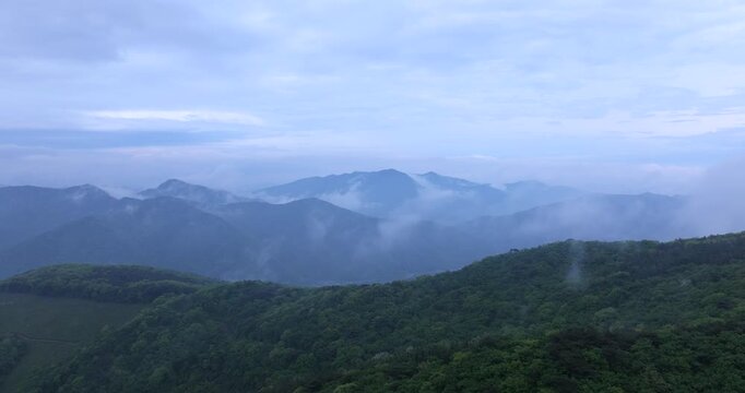 seongjusan, boryeong, south korea, aerial view, drone shot, hyperlapse, timelapse, mountain fog, mist, misty morning, cloudy sky, fast motion, atmospheric, majestic nature, serene landscape, pine tree