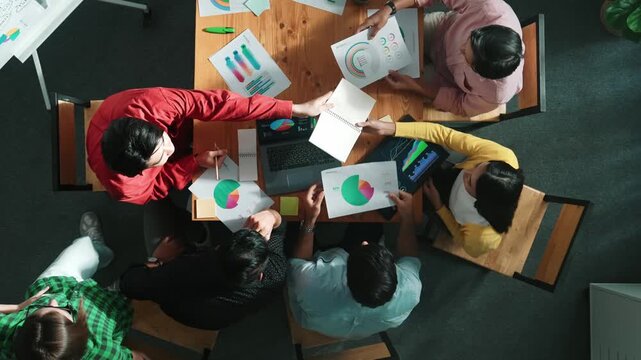 Time lapse of business people analyzing data and sharing idea about financial chart. Top down aerial view of marketing team discussing about investment plan and putting hand together. Convocation.