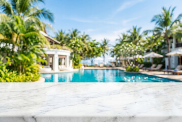 Obraz premium White marble tabletop with blurred tropical resort background