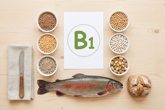 Assortment of healthy foods rich in vitamin b1 arranged around a paper sign on a wooden table