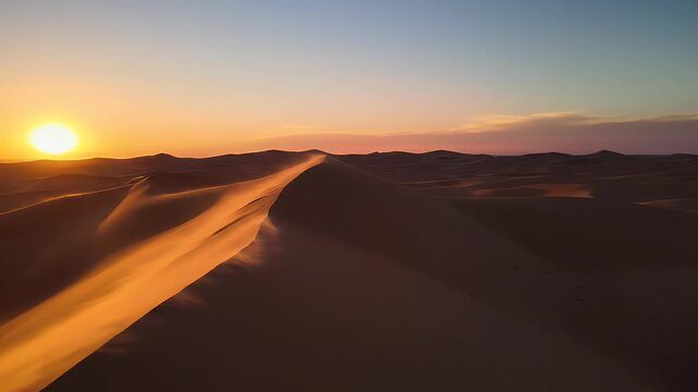 Rippling sand dunes glow under a soft gradient sky at sunset