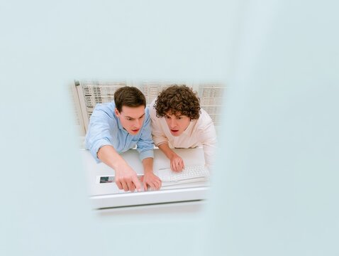Two focused professionals working at a workstation with bright copy space for cybersecurity and IT emergency response and alert data visualization