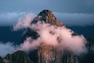 Fototapeta premium Ancient mountain peak citadel emerging through swirling mist, weathered stone terraces and ruins on a rugged summit for travel and heritage editorial