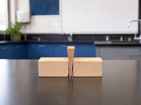 Wooden Wedge Splitting Two Blocks on a Science Laboratory Table