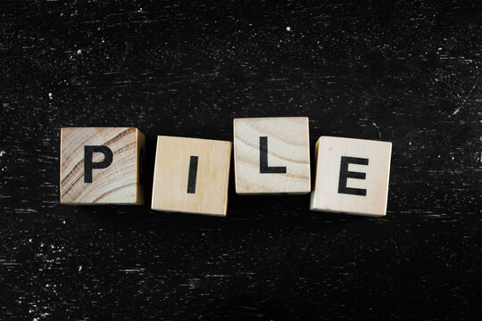 Wooden block with letter in black background