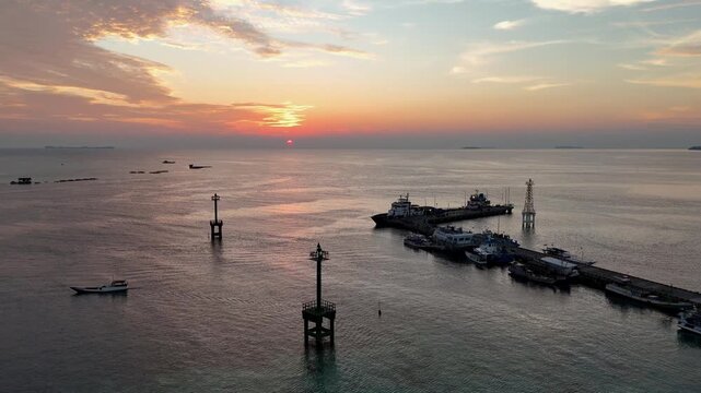 Stunning drone shot of Karimun Jawa coastline during a vibrant golden hour sunset.