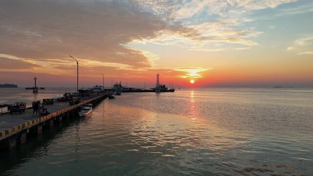 Stunning drone shot of Karimun Jawa coastline during a vibrant golden hour sunset.