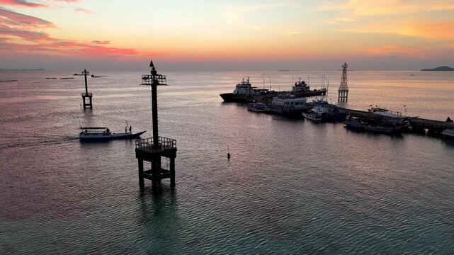 Stunning golden hour sky over the jetty in Karimunjawa Beach. Beautiful tropical island sunset landscape.
