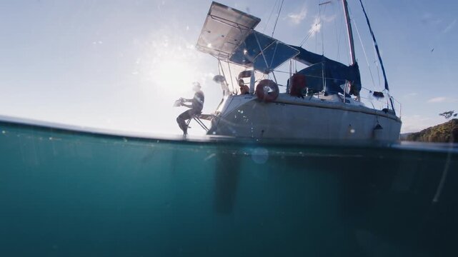 Freediving from the yacht. Freediver prepares for diving in the sea from sailing boat
