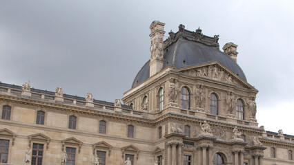 Fototapeta premium Ornate Stone Facade and Domed Pavilion of the Louvre Museum