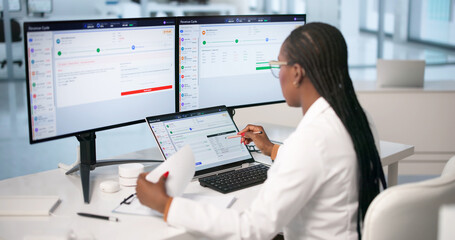 Young Woman Uses Laptop To Review Medical Billing