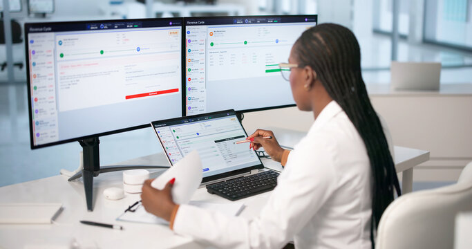 Young Woman Uses Laptop To Review Medical Billing