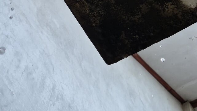 Rainwater Droplets Dripping From The Edge Of Old Leaky Rainwater Droplets Dripping From The Edge Of Old Leaky Concrete Roof Overhang