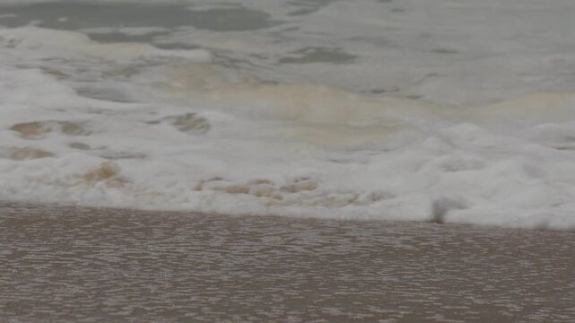 Close up of waves washing up on the sand