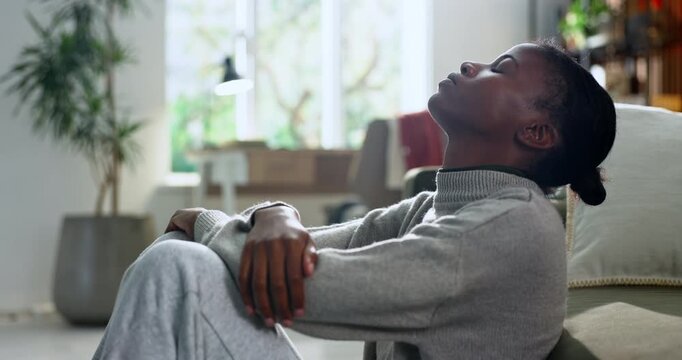 Black woman, stress and fear in home for mistake, overthinking or loss with pressure or regret. Trauma, panic or person with depression in living room with anxiety or overwhelmed by mental health