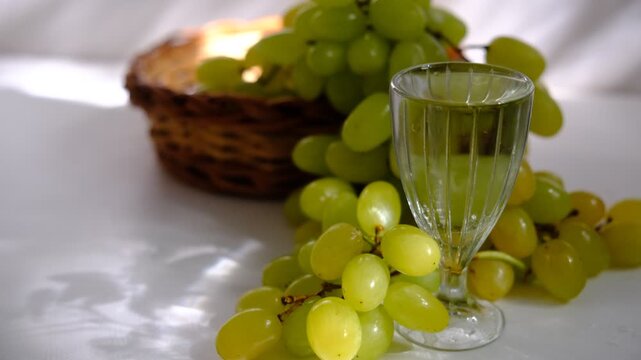 Alcoholic beverage, cacha&ccedil;a, tincture, vodka, grappa or brandy. strong and hard alcoholic drink. Fresh green grapes, creating a striking contrast between the potent spirit and the delicate fruit. 