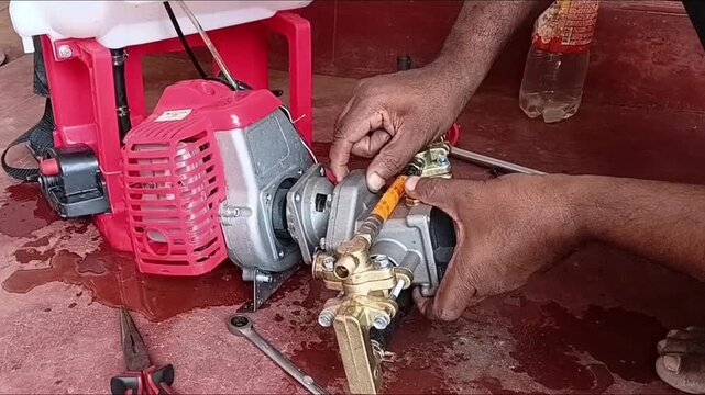 Mechanic Connecting And Mounting Brass Pressure Pump Unit Onto Two Stroke Gasoline Engine For Portable Power Sprayer Assembly
