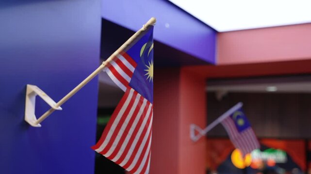 Close up of Malaysian national Flag Jalur Gemilang on Building Wall at Night illuminated Street Lighting