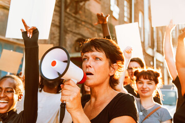 Protesters rallying with megaphone during a street demonstration