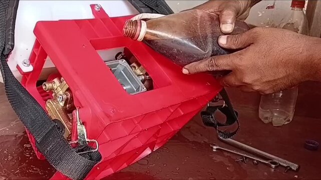 Changing Oil In Agricultural Power Sprayer Pressure Pump Pouring Lubricant Oil For Farm Equipment Maintenance
