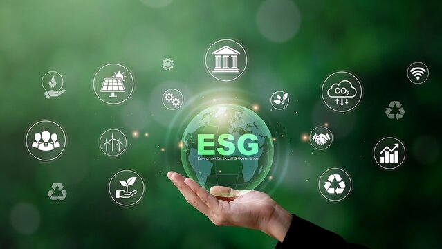 A person holds a glowing green globe with ESG icons surrounding it.