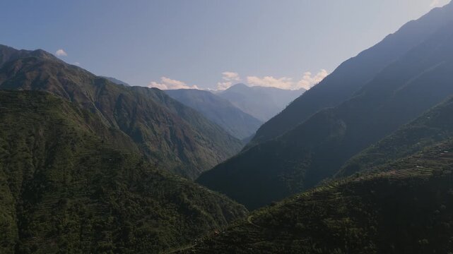 Low angle drone perspective charting a dramatic V-shaped deep mountain gorge valley