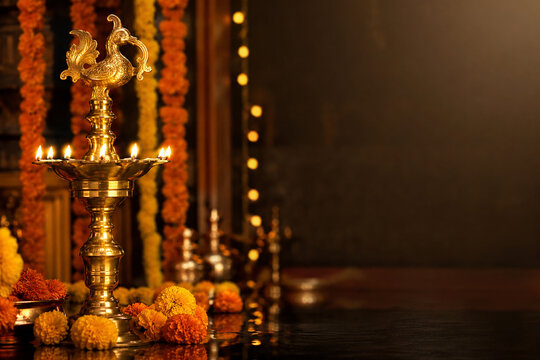 Traditional Brass Kuthu Vilakku Oil Lamp With Golden Bokeh Lights