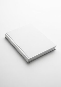 Blank white book lying on a surface
