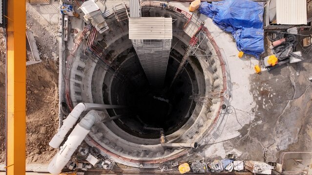 Aerial view of a deep circular construction shaft for a tunnel project with concrete walls, scaffolding, and industrial equipment in Istanbul, Istanbul, Turkiye.