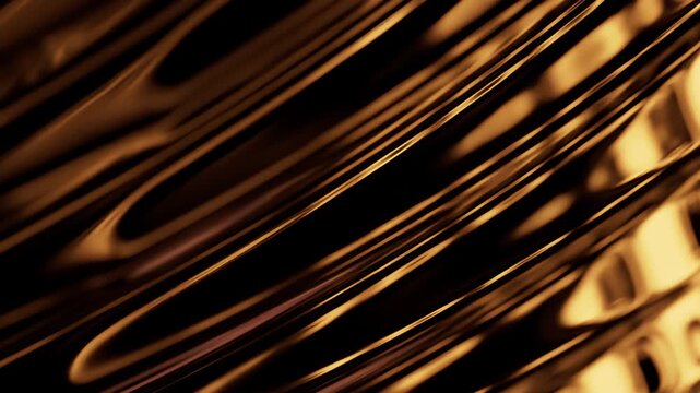 Golden glass ridges with deep shadows at upper left and bright amber refraction highlights at right side in wide horizontal frame