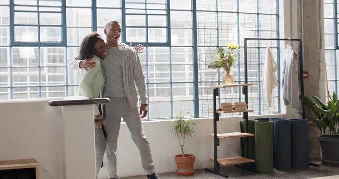 African American couple in gym clothes man entering right placing arm hugging heading to squat rack