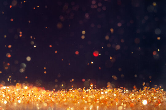 Swirling golden particles dance in darkness creating a vibrant visual display