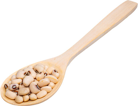 Wooden spoon filled with raw black eyed beans on a transparent background